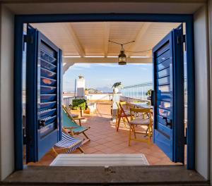 a view of a balcony with a table and chairs at Maison Artista in Procida