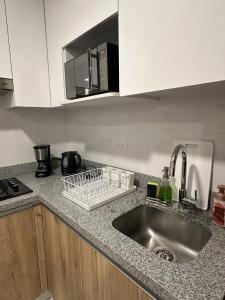 a kitchen counter with a sink and a microwave at Modern 2Br Apt Fully Furnished Barranco in Lima