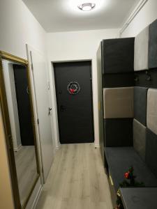 a hallway with a black door and a black door sidx sidx sidx at Heaven Paradise in Baia Mare