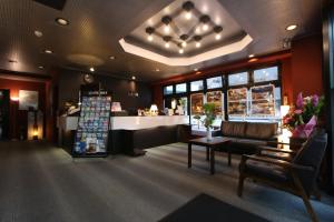 a store lobby with a couch and a counter at HOTEL LiVEMAX BUDGET Fuchu in Fuchu
