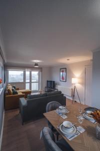 a living room with a couch and a table at Franklin Place in East Kilbride +29 photos