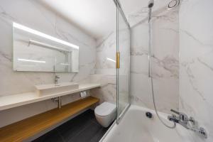 a bathroom with a shower and a sink and a toilet at Ecluses 15 - close to ski lift & centre - Nendaz in Nendaz +11 photos