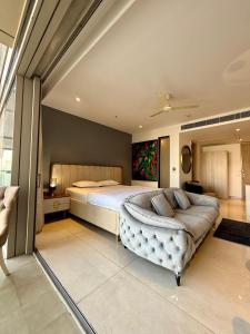 a bedroom with a large bed and a couch at New Private Turkish Luxe Jacuzzi Studio in Gurgaon