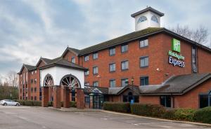 a large red brick building with a clock tower on top at Holiday Inn Express Stafford by IHG in Stafford