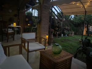 a patio with chairs and a table and an umbrella at Casa Tota in Trevignano Romano