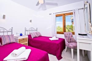 a bedroom with two beds and a mirror at Villa Kmar by Villa Plus in Cumbre del Sol +21 photos