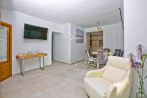 a living room with a couch and a table at Villa Kmar by Villa Plus in Cumbre del Sol