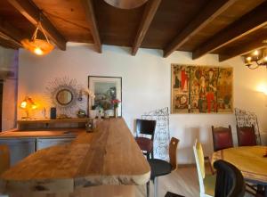 a dining room with a large wooden table and chairs at La Grange des zarts in Champagné-le-Sec