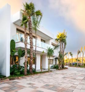 a building with palm trees in front of it at LE BLEU RESORT in Tangier