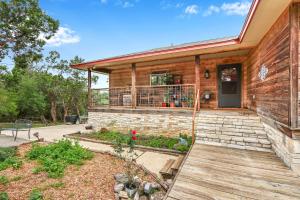 a home with a deck and a house at Painted Paradise Main House in New Braunfels
