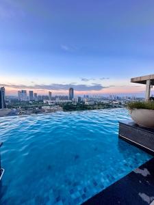 a swimming pool with a city skyline in the background at New Private Turkish Luxe Jacuzzi Studio in Gurgaon +45 photos