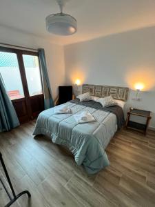 a bedroom with a large bed and a large window at Casas de Valtravieso El Jardín in El Pozo de los Frailes