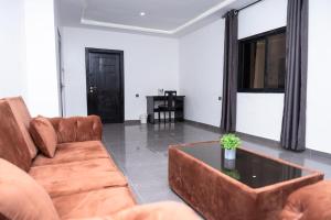 a living room with a couch and a coffee table at Airport INN Hotel in Lomé