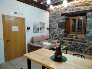 a living room with a table and a couch at Apartamento Rural Malkorpe in Lekunberri