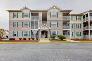 a large apartment building with a street in front of it at Creekwood --- 1400 Pebble Dr #1410 in The Plantations