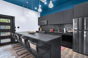 a kitchen with a large black island with chairs at Little Blanca in Canyon Lake