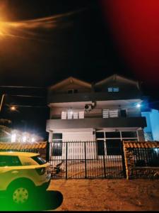 a yellow car parked in front of a house at night at Villa Milla in Veles