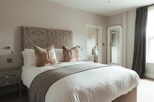 a bedroom with a large bed with white sheets and pillows at The Goudhurst Inn in Goudhurst