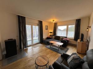 a living room with a couch and a table at Ferienhaus Denise Harz in Sankt Andreasberg