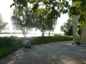a barrel sitting on the side of a road at Chateau de la Vieille Chapelle in Lugon et l’Ile du Carney