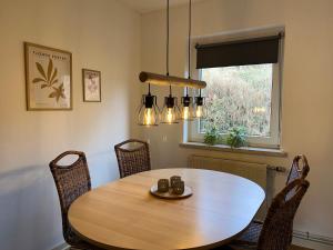 a dining room with a wooden table and chairs at Ferienhaus Denise Harz in Sankt Andreasberg