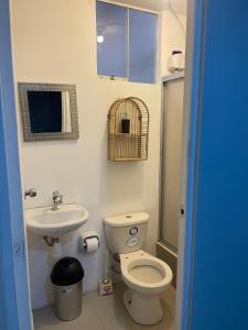 a small bathroom with a toilet and a sink at Casa Apartament Paseo Del Mar in Chimbote