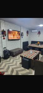 a living room with two tables and a flat screen tv at Guesthouse with event venue in Argavand