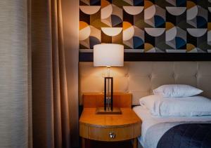 a room with a bed and a table with a lamp at Platinum Ostróda in Ostróda +62 photos