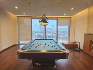 a pool table with balls on it in a room at Luxe 2 BHK with Stunning Views in Gurgaon