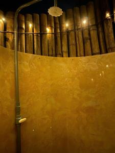 a large yellow wall in a wine cellar at night at BOHO Glamping - CẮM TRẠI HỒ TRỊ AN in Ấp Phú Cát