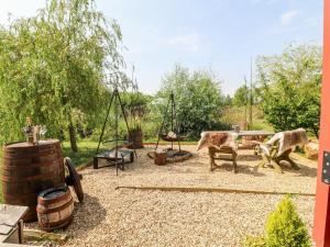 two animals in a playground with a table and swings at Bonnie's Shepherds Hut at Shepherds Lodge Retreat and Wellness in Nottingham