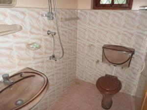 a bathroom with a tub and a toilet and a sink at Mayura Rest Inn in Tissamaharama