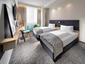 Postel nebo postele na pokoji v ubytování Clarion Hotel Vienna South