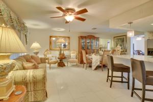a living room with a couch and a table at St Petersburg Home with Tropical Yard and Pool! in St Petersburg