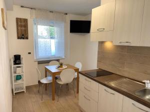 a kitchen with a table and a small table and chairs at Friedrich Apartments in Merano +20 photos
