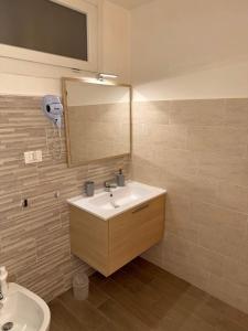 a bathroom with a sink and a mirror at Friedrich Apartments in Merano