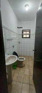 a bathroom with a sink and a toilet at Apartamento Ilha comprida centro in Ilha Comprida +30 photos
