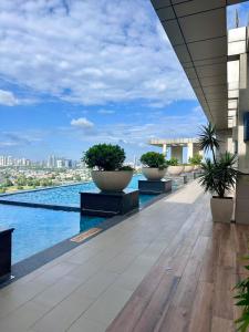 a building with a pool with potted plants on it at Luxe 2 BHK with Stunning Views in Gurgaon