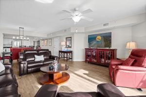 a living room with leather furniture and a table at Yacht Club Villas 1-505 - Marina View in Myrtle Beach
