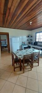 a kitchen with a table and benches in a room at Apartamento Ilha comprida centro in Ilha Comprida