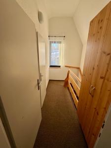 an attic hallway with a door and a window at Haus Leo in Bad Mitterndorf +4 photos