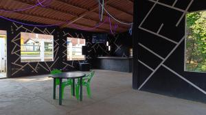 un tavolo e due sedie verdi davanti a un edificio di Finca 7 Reyes Casa con alberca a Villa del Carbón Altre 5 foto