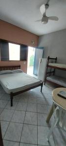 a bedroom with a bed and a table at Apartamento Ilha comprida centro in Ilha Comprida