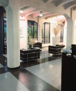 a large lobby with black floors and windows at Exelente alojamiento in Buenos Aires +10 photos