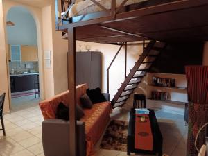 a living room with a couch and a loft bed at 'In My Place' Monolocale soppalcato Open space in Genzano di Roma