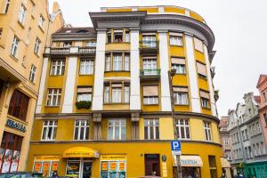 a yellow and white building on a city street at Retro Hostel in Poznań