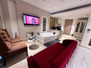 a living room with a couch and a tv on the wall at Luxury Studios Key 4 in Gurgaon