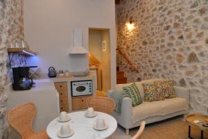 a living room with a couch and a table and chairs at Caeli's Home in Gythio