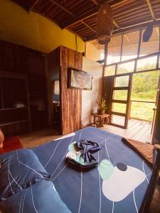 a room with a blue table with a plate of food on it at Utria hostel in El Valle