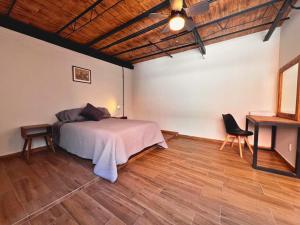 a bedroom with a bed and a wooden floor at Discover Condesa Ideal Location in Mexico City